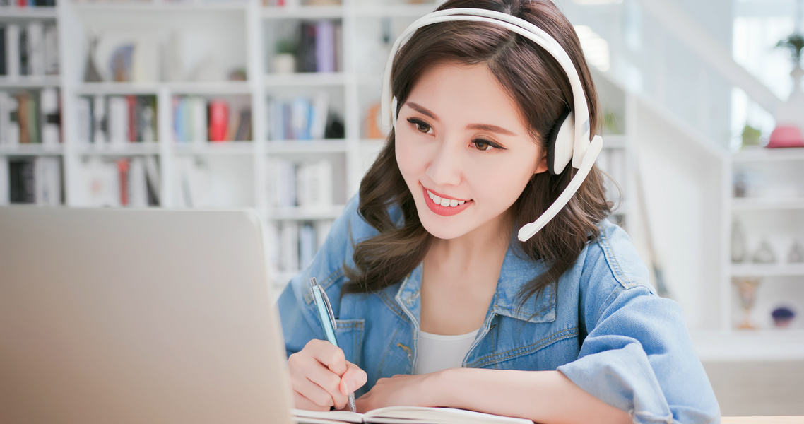 Young Woman Listening to Online Lecture